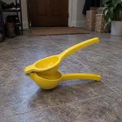 yellow handheld hinged citrus squeezer, as photographed