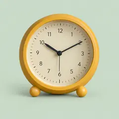 round ochre analog table clock on two small feet, as a cover photo