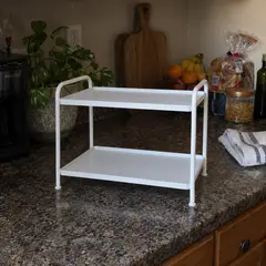 small white two-tier freestanding shelf, as photographed