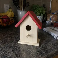 small pale wood birdhouse, as photographed