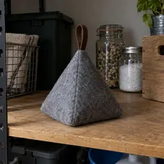 gray felt pyramid doorstop, as photographed