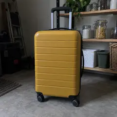 mustard hard-shell carry-on suitcase, as photographed