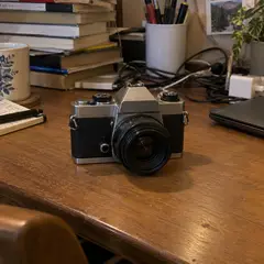 small silver and black vintage-style camera, as photographed