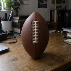 plain brown stitched leather football, as photographed