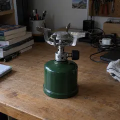 small green single-burner camping stove, as photographed