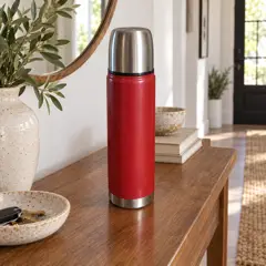 red cylindrical vacuum thermos, moved into a new room