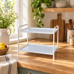 small white two-tier freestanding shelf, moved into a new room