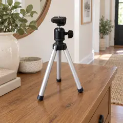 small silver tabletop tripod, moved into a new room