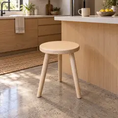 round pale wood stool, moved into a new room