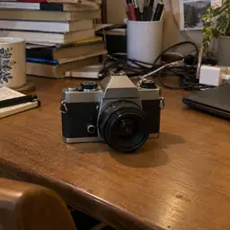 small silver and black vintage-style camera, as photographed