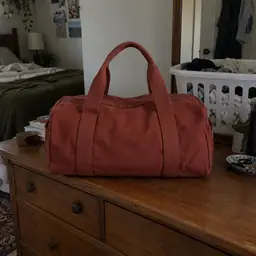 brick-red canvas duffel bag, as photographed