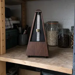 walnut pyramid mechanical metronome, as photographed