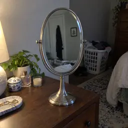 oval silver tabletop mirror, as photographed