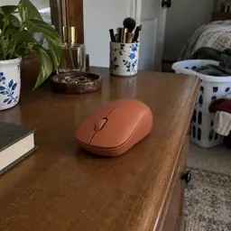 terracotta wireless computer mouse, as photographed