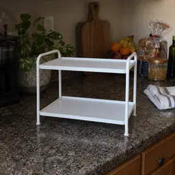 small white two-tier freestanding shelf, as photographed