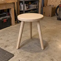 round pale wood stool, as photographed