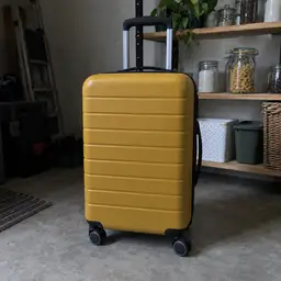 mustard hard-shell carry-on suitcase, as photographed